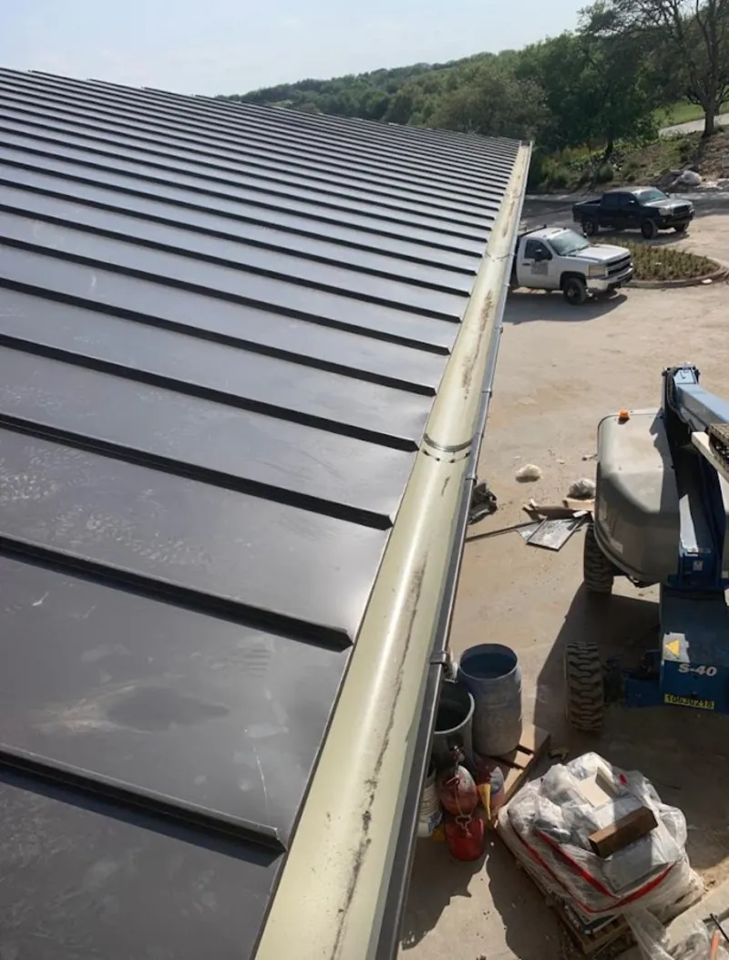 Standing seam panel and gutter detail on a metal roofing jobsite in Cypress Gardens